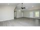 Bright living room featuring gray flooring, high ceilings, and a modern ceiling fan at 5576 Foothills Ct, Snow Camp, NC 27349