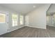 Bright living room featuring sleek gray flooring, recessed lights, neutral paint, and plenty of natural light at 5576 Foothills Ct, Snow Camp, NC 27349