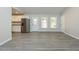 Open living room featuring gray flooring and a view of the kitchen at 5576 Foothills Ct, Snow Camp, NC 27349