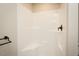 A standard shower with white walls and a black shower head and towel rack at 5576 Foothills Ct, Snow Camp, NC 27349
