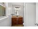 Bathroom featuring wood cabinets, granite countertop, illuminated mirror, and neutral wall color at 5820 Wake Forest Hwy, Durham, NC 27703