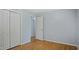 Bedroom featuring hardwood floors, a light gray wall color, closet, and neutral trim at 5820 Wake Forest Hwy, Durham, NC 27703