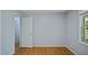 Bedroom featuring hardwood floors, a light gray wall color, and neutral trim at 5820 Wake Forest Hwy, Durham, NC 27703