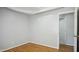 A cozy room with hardwood floors, neutral walls, and a glimpse of an interior door at 5820 Wake Forest Hwy, Durham, NC 27703