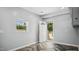 Bright entry room features wood-look chevron flooring, a window, and a white door leading to the outside at 5820 Wake Forest Hwy, Durham, NC 27703