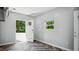 Bright entry room features wood-look chevron flooring, neutral walls, and a white door leading to the outside at 5820 Wake Forest Hwy, Durham, NC 27703