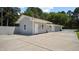 Side view of a building showing plain exterior walls, multiple doors, and windows, plus a paved lot at 5820 Wake Forest Hwy, Durham, NC 27703