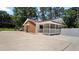 Charming one-story brick home with a covered patio, a white picket fence, and a spacious paved driveway at 5820 Wake Forest Hwy, Durham, NC 27703