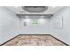 A bright flex room with herringbone floors, recessed lights, and modern ceiling at 5820 Wake Forest Hwy, Durham, NC 27703