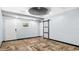 Well-lit flex room with unique herringbone wood floors and modern ceiling at 5820 Wake Forest Hwy, Durham, NC 27703
