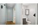 Hallway with an open view to adjacent bathroom featuring neutral color palette at 5820 Wake Forest Hwy, Durham, NC 27703