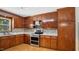 Well-equipped kitchen boasting stainless steel appliances, custom wood cabinets, and attractive backsplash at 5820 Wake Forest Hwy, Durham, NC 27703