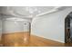 Spacious living area featuring hardwood floors, elegant lighting, and access to barn door at 5820 Wake Forest Hwy, Durham, NC 27703