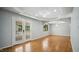 Open living area with hardwood flooring, tray ceiling, modern light fixtures, and french doors at 5820 Wake Forest Hwy, Durham, NC 27703