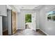 A bright entryway with herringbone floors, a rustic sliding door, and a view to the outdoors at 5820 Wake Forest Hwy, Durham, NC 27703