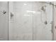 A sleek, glass-enclosed shower with modern fixtures and elegant marble-patterned tiles at 5820 Wake Forest Hwy, Durham, NC 27703
