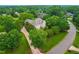 Breathtaking aerial view of a beautiful home surrounded by lush greenery and mature trees, offering a sense of privacy at 6005 Carlyle Dr, Raleigh, NC 27614