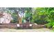 Backyard stone patio with a basketball hoop, a sitting area, and lush landscaping for private seating at 6005 Carlyle Dr, Raleigh, NC 27614