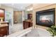 Luxurious bathroom featuring a soaking tub, fireplace, granite counters, and walk-in shower at 6005 Carlyle Dr, Raleigh, NC 27614