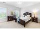 Serene bedroom with dark wood furniture, neutral tones, carpet, and soft lighting, creating a peaceful retreat at 6005 Carlyle Dr, Raleigh, NC 27614