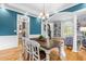 The dining room is filled with natural light and includes hardwood floors and a large table at 6005 Carlyle Dr, Raleigh, NC 27614
