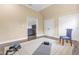 Exercise room featuring hardwood flooring, neutral paint, doorway to living room, and assorted workout equipment at 6005 Carlyle Dr, Raleigh, NC 27614