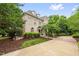 Charming brick home with well-maintained landscaping, featuring a lush lawn and mature trees, offering a peaceful retreat at 6005 Carlyle Dr, Raleigh, NC 27614