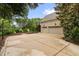 Spacious three-car garage with ample parking space, surrounded by lush landscaping and mature trees for added privacy at 6005 Carlyle Dr, Raleigh, NC 27614