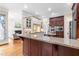 A gourmet kitchen features granite counters, custom cabinets, and stainless steel appliances at 6005 Carlyle Dr, Raleigh, NC 27614