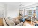 Open living room featuring hardwood floors and a large window overlooking the backyard at 6005 Carlyle Dr, Raleigh, NC 27614
