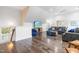 Open living room with wood floors, large TV, modern furnishings, and natural light at 6005 Carlyle Dr, Raleigh, NC 27614
