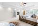 Spacious main bedroom features a fireplace, tray ceilings, ceiling fan and large windows at 6005 Carlyle Dr, Raleigh, NC 27614