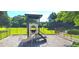 Community playground with slide and green space, surrounded by black metal fencing and mature trees at 6005 Carlyle Dr, Raleigh, NC 27614