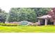 Stone community entrance sign for 'Carlyle at Falls Lake' surrounded by manicured landscaping and trees at 6005 Carlyle Dr, Raleigh, NC 27614