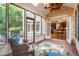Charming sunroom boasts brick walls, a ceiling fan, and natural light with an open view to the kitchen at 6005 Carlyle Dr, Raleigh, NC 27614