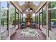A sunroom features skylights, a fireplace, ceiling fan, and a comfortable seating area at 6005 Carlyle Dr, Raleigh, NC 27614