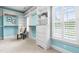 Walk-in closet features a built-in dresser and custom shelving plus window with shutters at 6005 Carlyle Dr, Raleigh, NC 27614