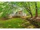 Home exterior featuring a stone retaining wall with lush grass at 604 Eden Ln, Chapel Hill, NC 27517