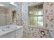 Charming bathroom with bright seashell wallpaper, large mirror, and natural light at 604 Eden Ln, Chapel Hill, NC 27517