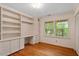 Bedroom with built-in shelves, drawers, and a window for natural light at 604 Eden Ln, Chapel Hill, NC 27517