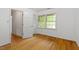 Bedroom with hardwood floors, white walls, and natural light from the window at 604 Eden Ln, Chapel Hill, NC 27517