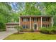 Charming brick home featuring a classic design, well-manicured lawn and mature trees at 604 Eden Ln, Chapel Hill, NC 27517