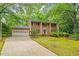 Beautiful brick home with attached garage, driveway and a lush green lawn at 604 Eden Ln, Chapel Hill, NC 27517