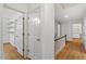 Hallway with wood floors, white trim, and doors leading to various rooms at 604 Eden Ln, Chapel Hill, NC 27517