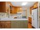 Kitchen with white countertops, white appliances, and light wood cabinets at 604 Eden Ln, Chapel Hill, NC 27517