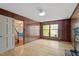 Cozy living room featuring wood paneling, fireplace, and hardwood floors at 604 Eden Ln, Chapel Hill, NC 27517