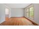 Bright living room features hardwood floors and a large window for natural light at 604 Eden Ln, Chapel Hill, NC 27517