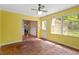 Bright sunroom with yellow walls and brick floors offers lots of natural light at 604 Eden Ln, Chapel Hill, NC 27517