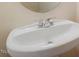Simple white pedestal sink with chrome fixtures, offering a clean and functional design for a small bathroom or powder room at 615 Carlton Commons Ln, Cary, NC 27519