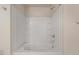 Clean bathtub with a shower head, grab bar and built in wall shelves at 615 Carlton Commons Ln, Cary, NC 27519